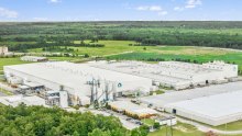 A light colored manufacturing facility and warehouse as seen from above.